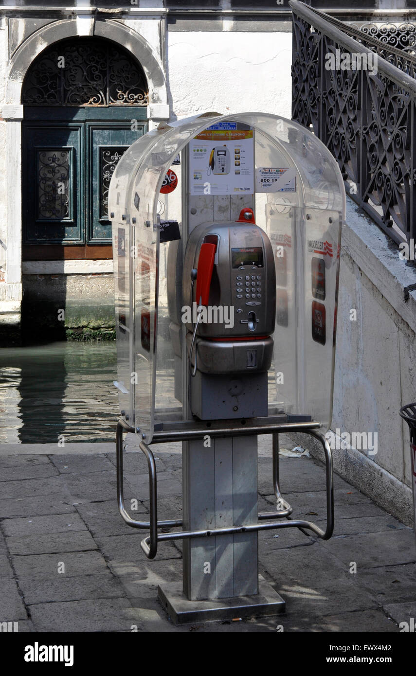 Italy  Venice Cannaregio region canal side telephone booth - 21st century technology in an ancient waterside setting Stock Photo