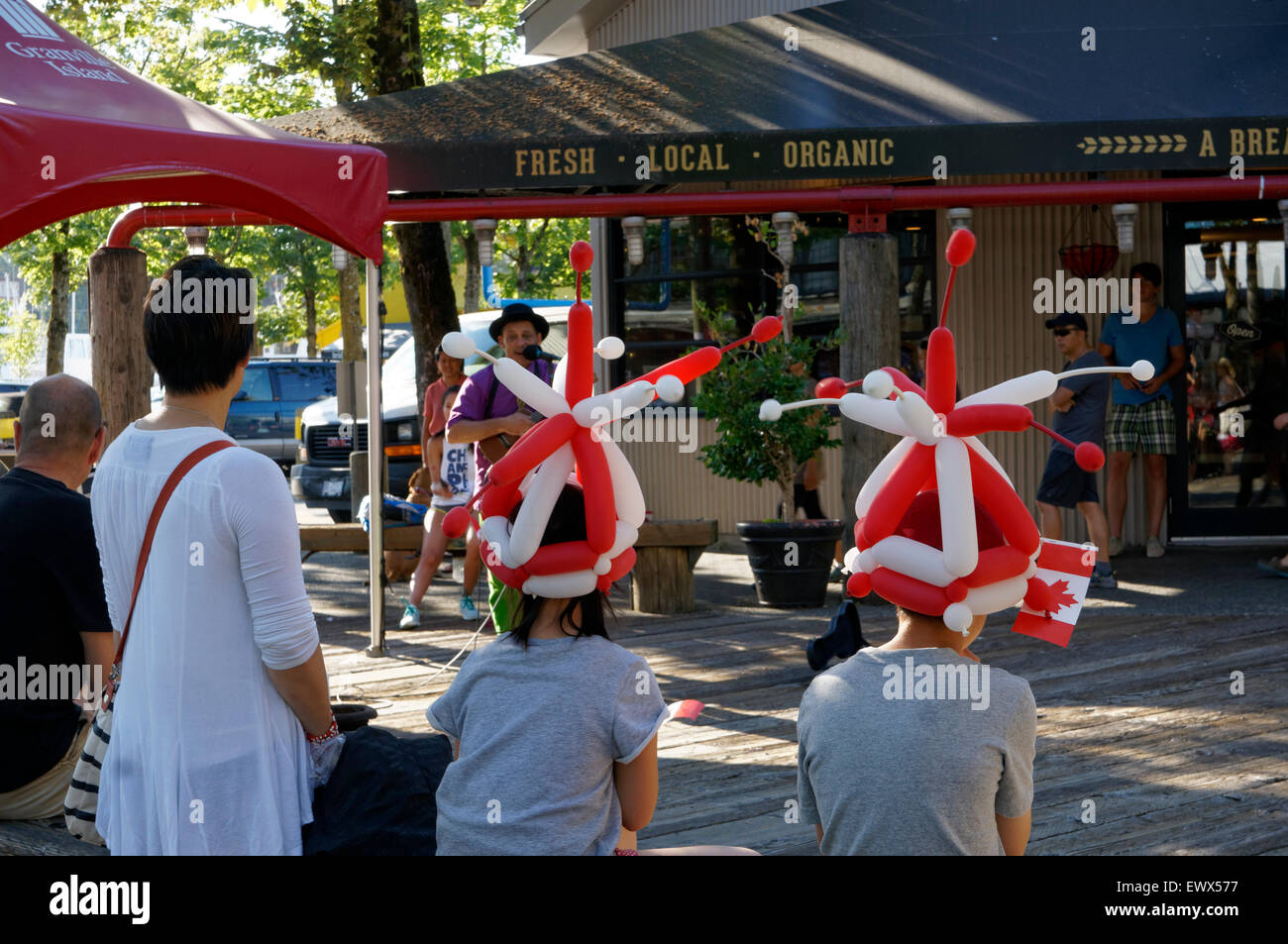 A busker entertains children at Canada Day celebrations on Granville
