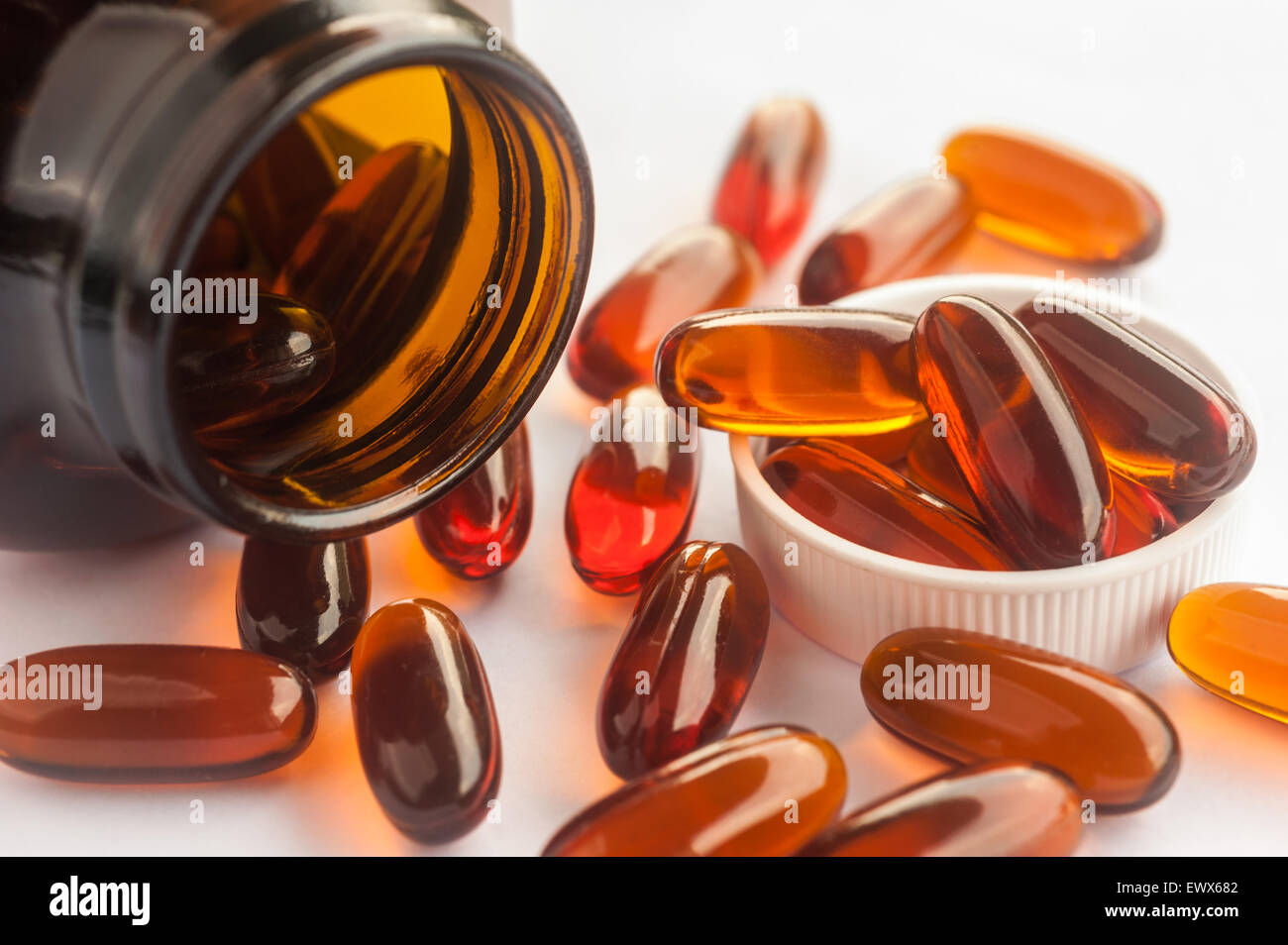 Vitamin in capsule spilling out of a bottle, Vitamin for health Stock Photo