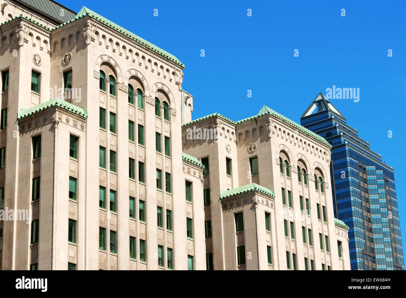On the left the Dominion Square Building or Gazette Building in Beaux Arts Style and modern style McGill Tower in Montreal Stock Photo