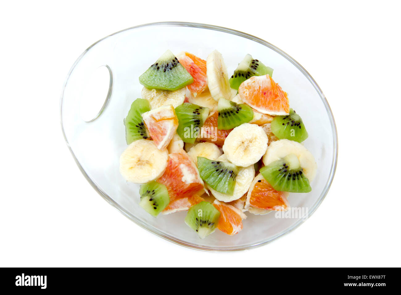 Bowl with sliced fruit on a white background top view Stock Photo
