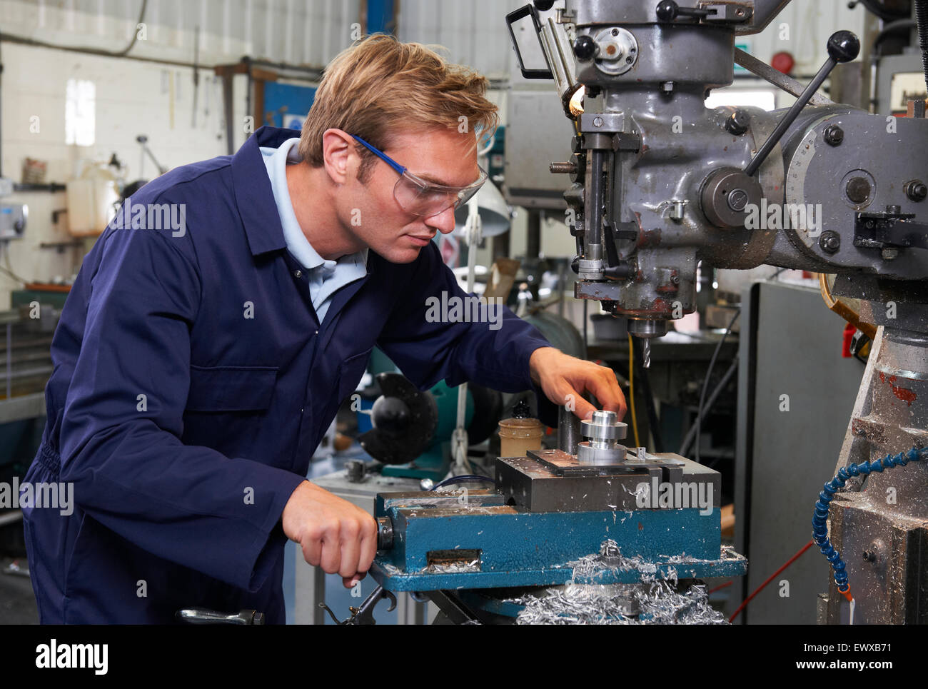 Engineer Using Drill In Factory Stock Photo