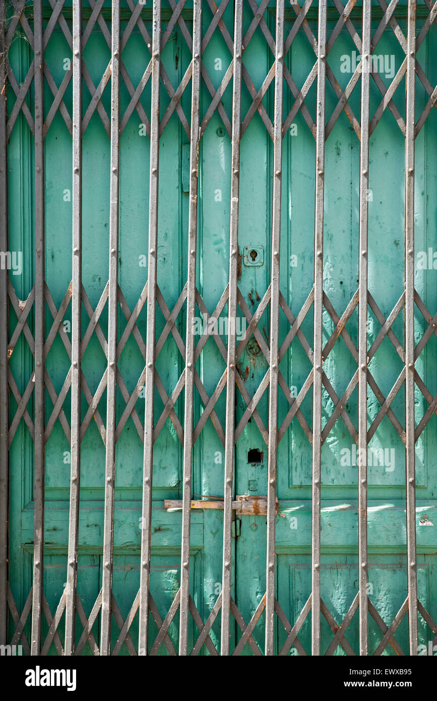 Folding old metal door gate of abandoned store Stock Photo