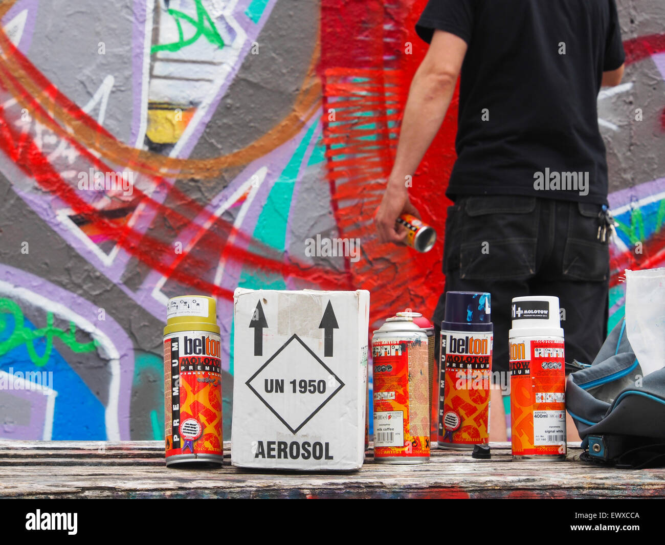 Graffiti writer with his spray cans Stock Photo