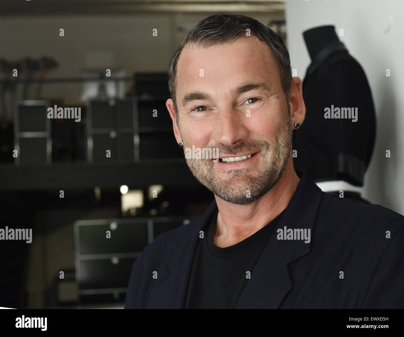 Berlin, Germany. 1st July, 2015. EXCLUSIVE - German fashion designer Michael Michalsky smiles as he is pictured in his studio in Berlin, Germany, 1 July 2015. Photo: Jens Kalaene/dpa/17�Թ����� Live News Stock Photo