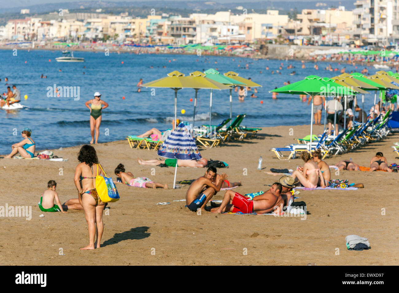 People on Capital Rethymno Beach, Crete vacation Greece beach sunbathers Stock Photo