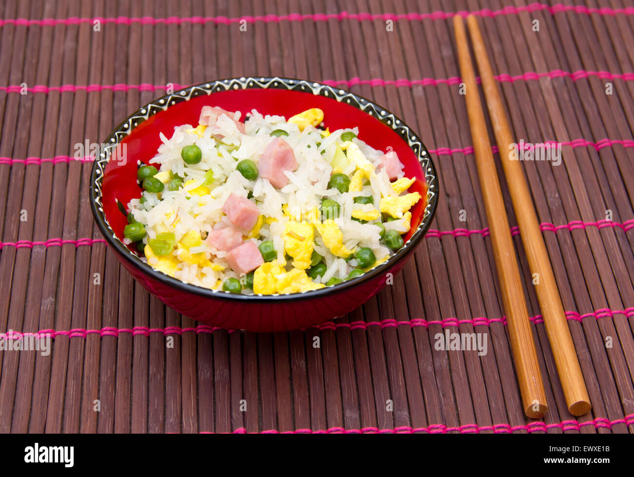 Cantonese rice with chopsticks on bamboo tablecloth Stock Photo