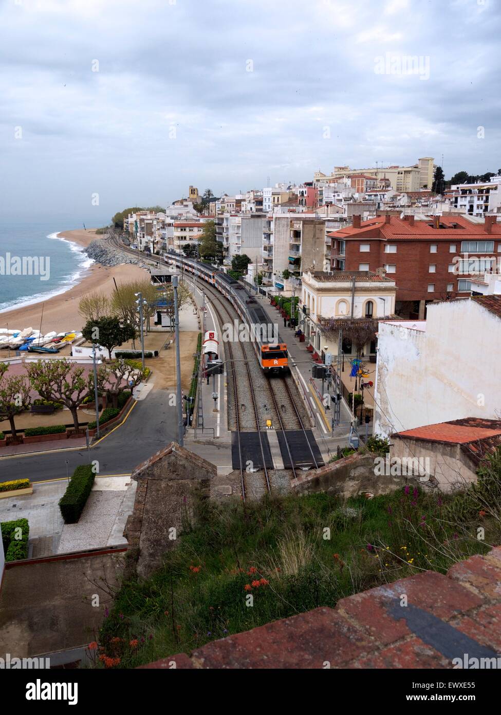 Train station in a traditional Spanish village on One side and a beach on the other Stock Photo