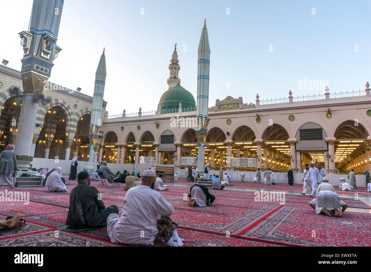 MEDINA, SAUDI ARABIA - MARCH 09, 2015 : Muslims read Quran and pray inside Nabawi mosque. Stock Photo