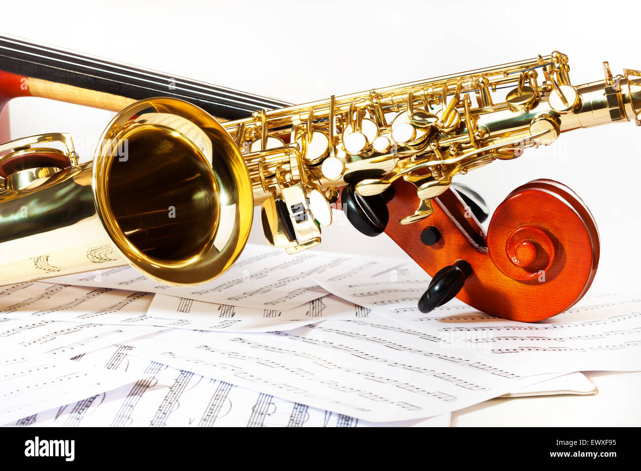 Cello tuning pegs and shiny golden alto saxophone Stock Photo Alamy