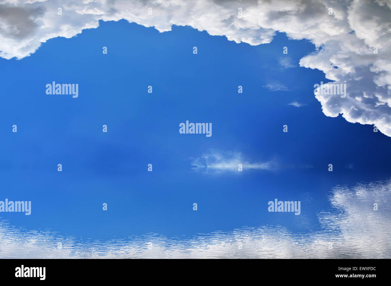 Fluffy clouds in the bright blue sky Stock Photo - Alamy