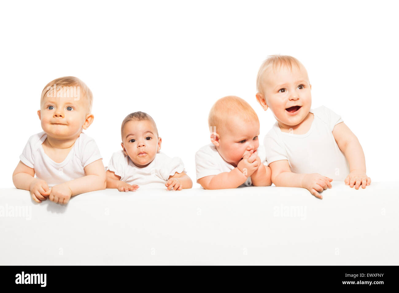 Cute babies stand in a row on the white background Stock Photo