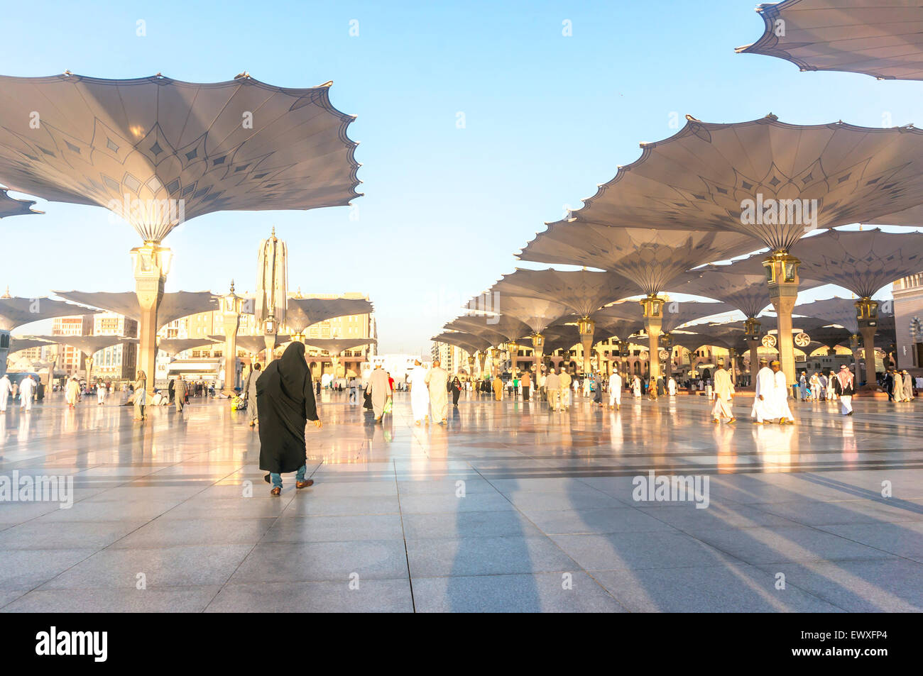 MEDINA, SAUDI ARABIA MARCH 06, 2015 Pilgrims walk underneath giant