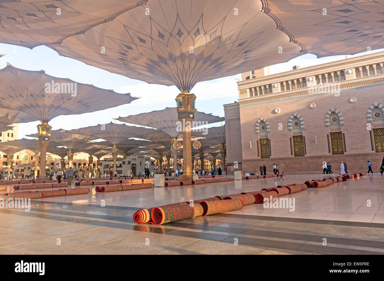 MEDINA MARCH 06 Pilgrims walk underneath giant umbrellas at Nabawi Mosque compound on March