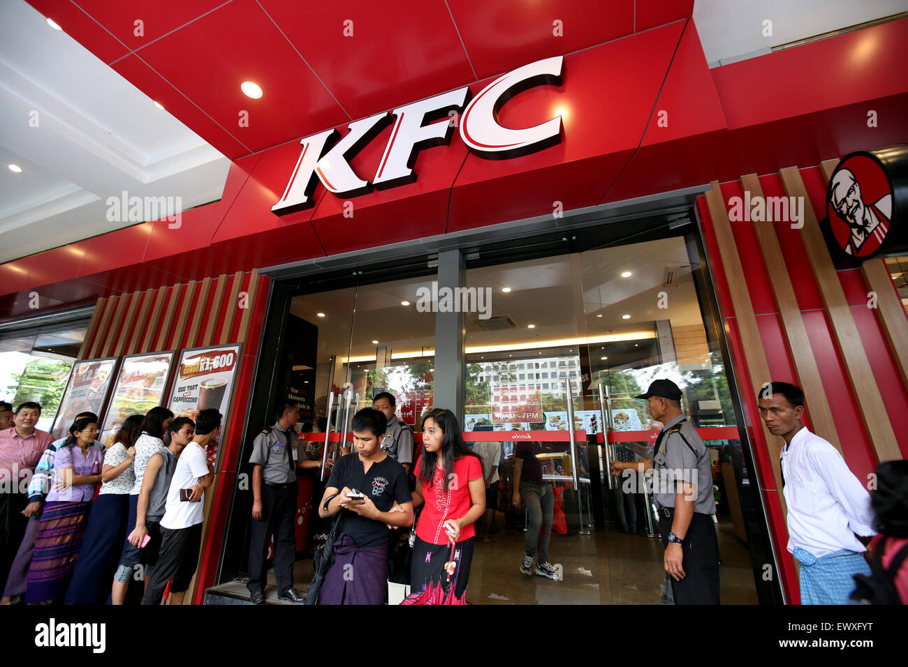Yangon, Myanmar. 2nd July, 2015. Securities stand outside a KFC branch in Yangon, Myanmar, July 2, 2015. Leading fast food brand KFC opened its first branch in Myanmar on June 30. © U Aung/Xinhua/Alamy Live News Stock Photo