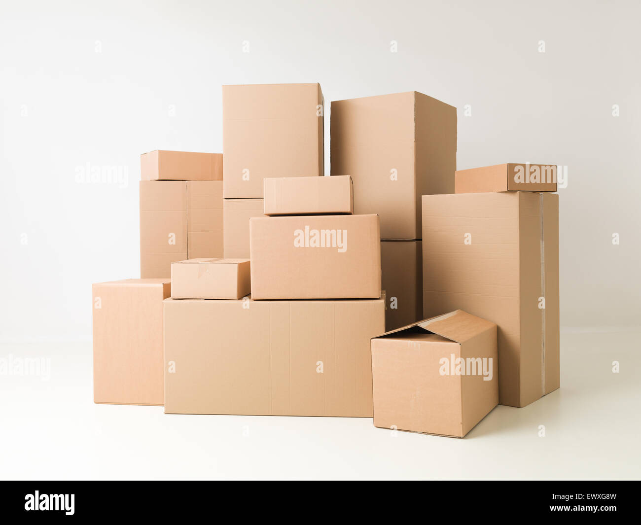 stack of cardboard boxes on white background Stock Photo - Alamy