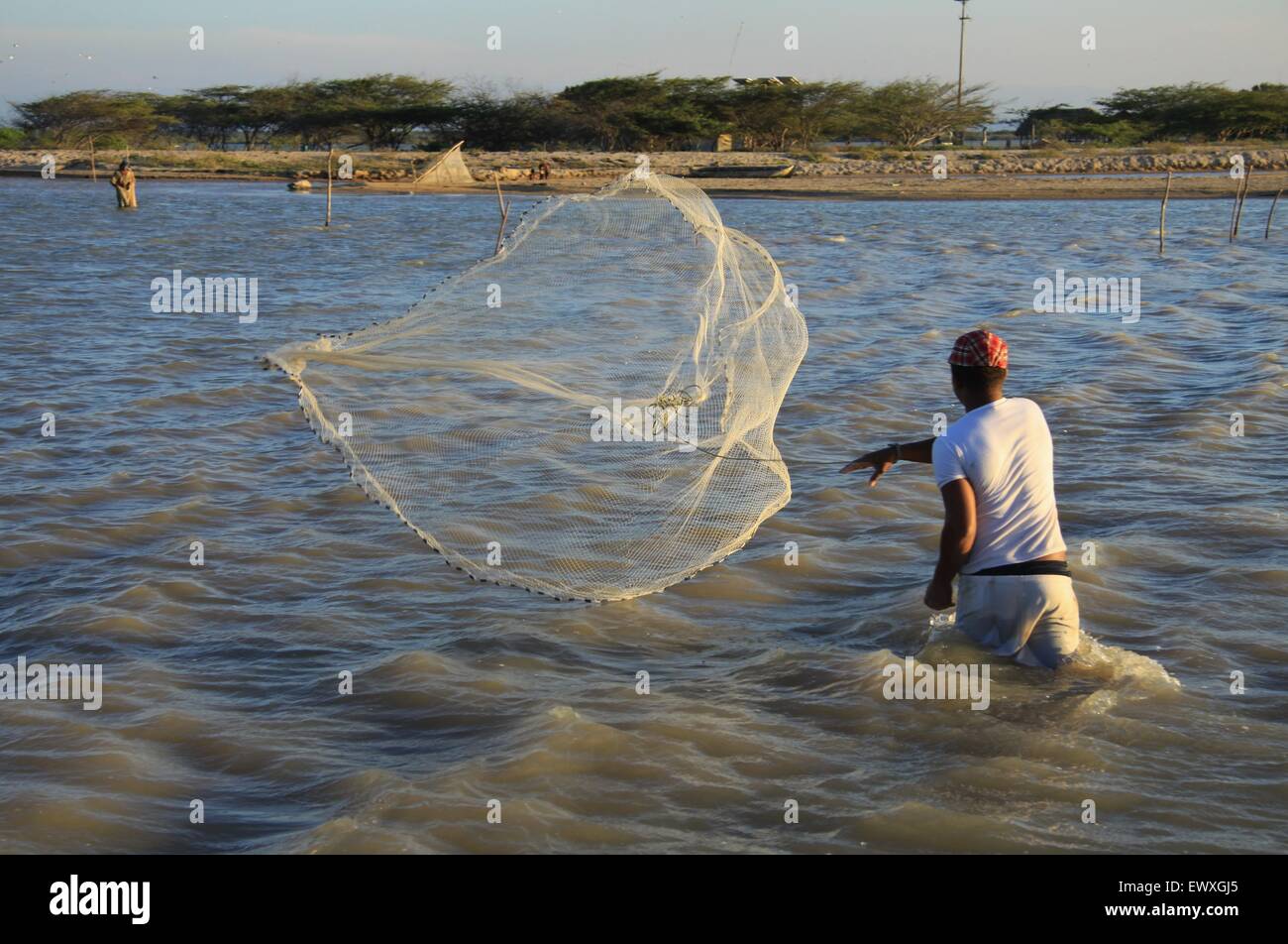 Fisherman throwing his net Stock Photo - Alamy