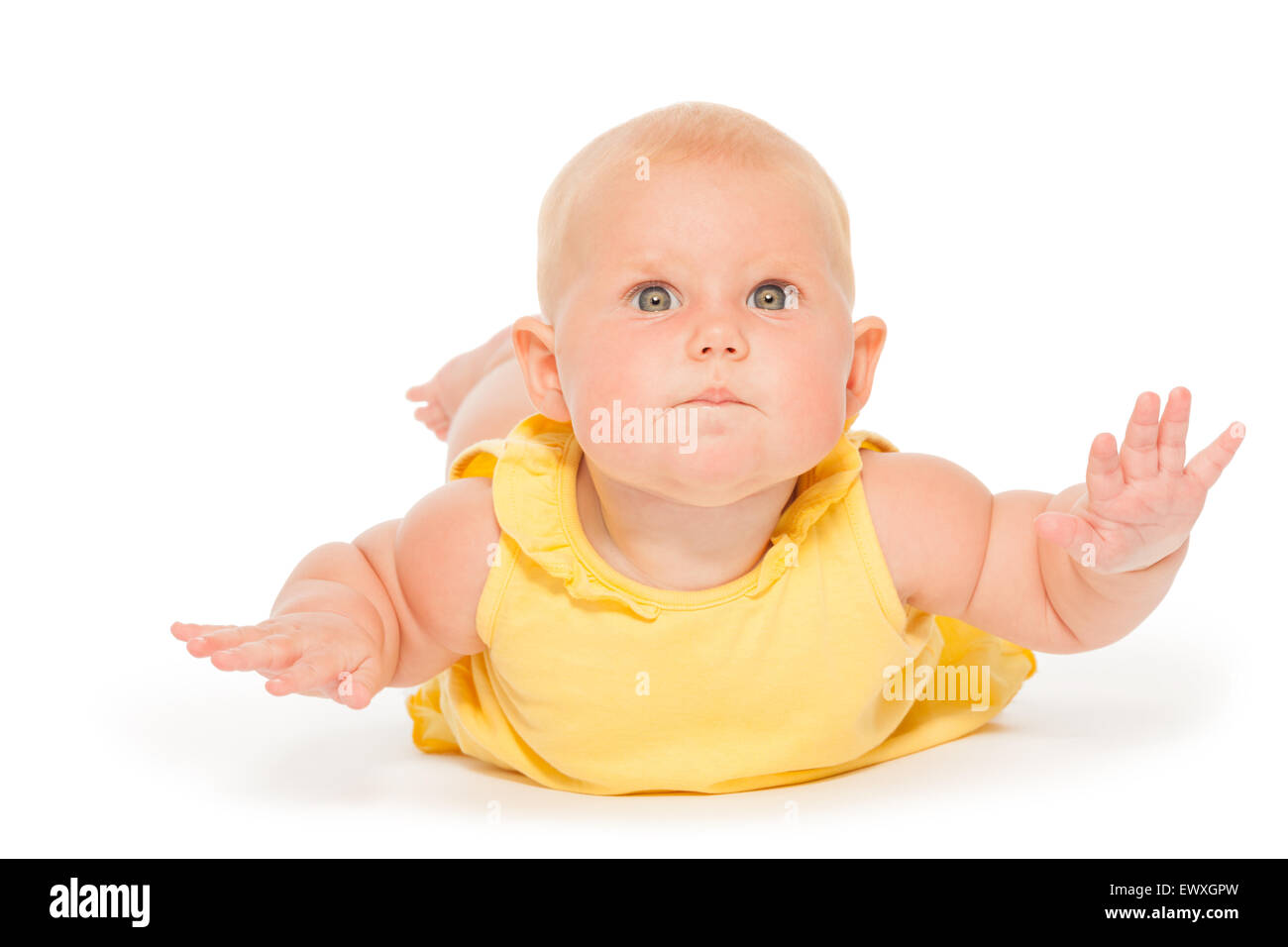 Chubby baby laying on the belly in yellow bodysuit Stock Photo