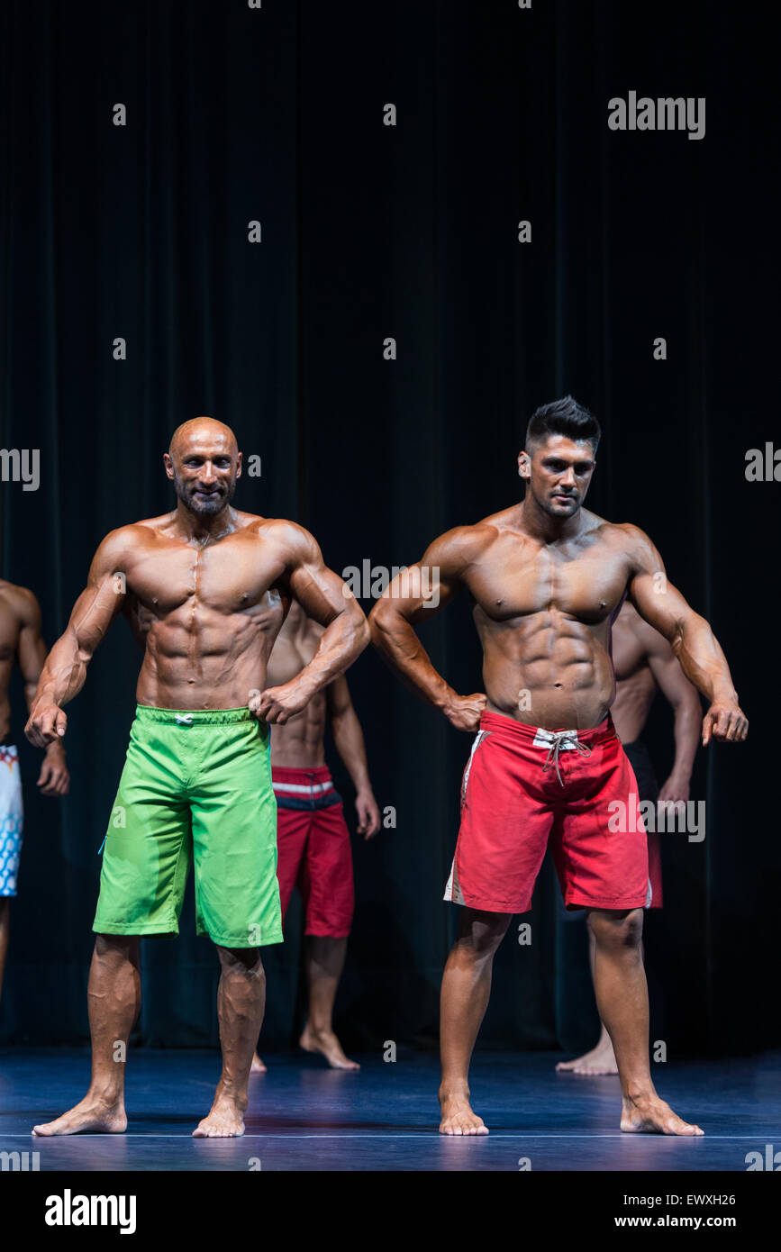 Mens Physique Posing During A Bodybuilding Competition Stock Photo Alamy