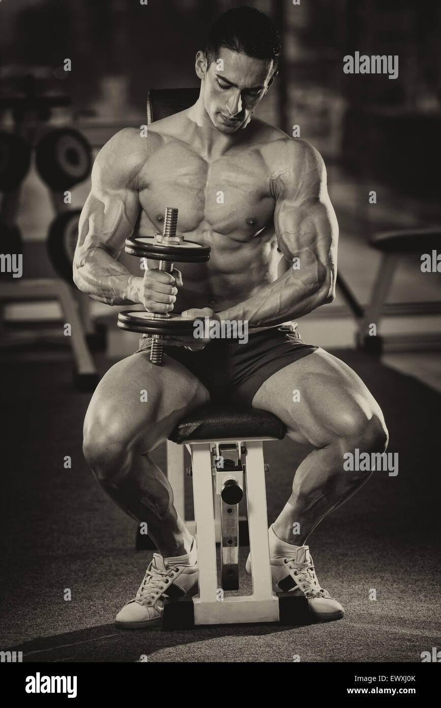 Young Man Working Out Biceps - Dumbbell Concentration Curls Stock Photo ...