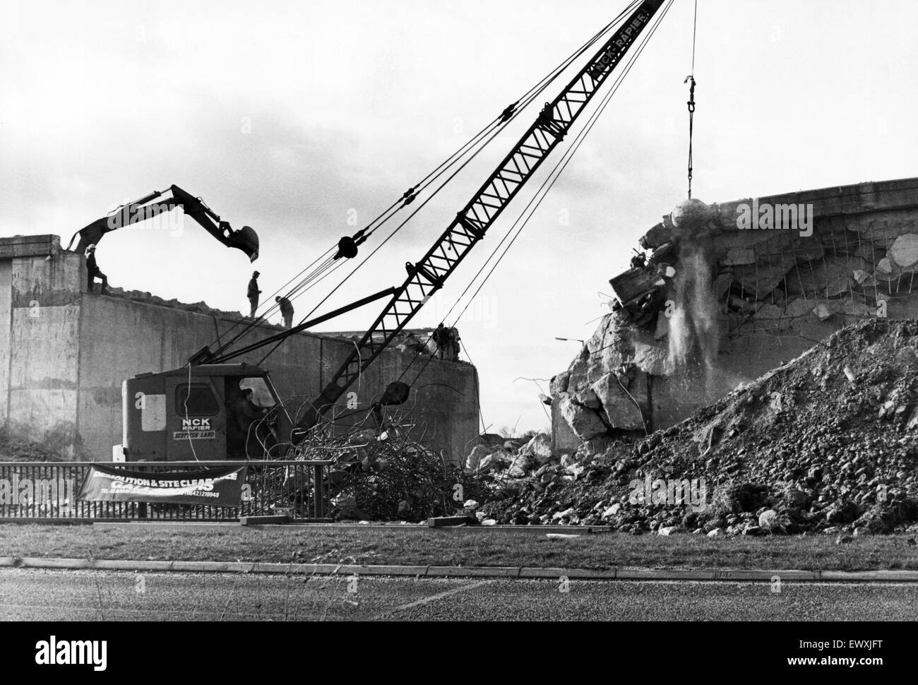 The demolition of the final section of the old A19 Wolviston interchange flyover is nearly finished as the giant ball smashes its way through. 26th January 1983. Stock Photo