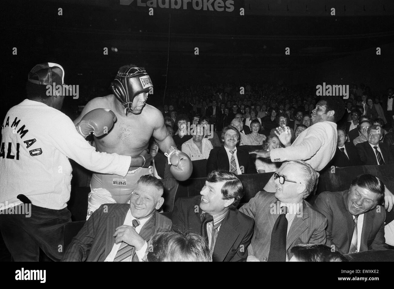 Muhammad Ali having fun with a spectator at boxing exhibition match in