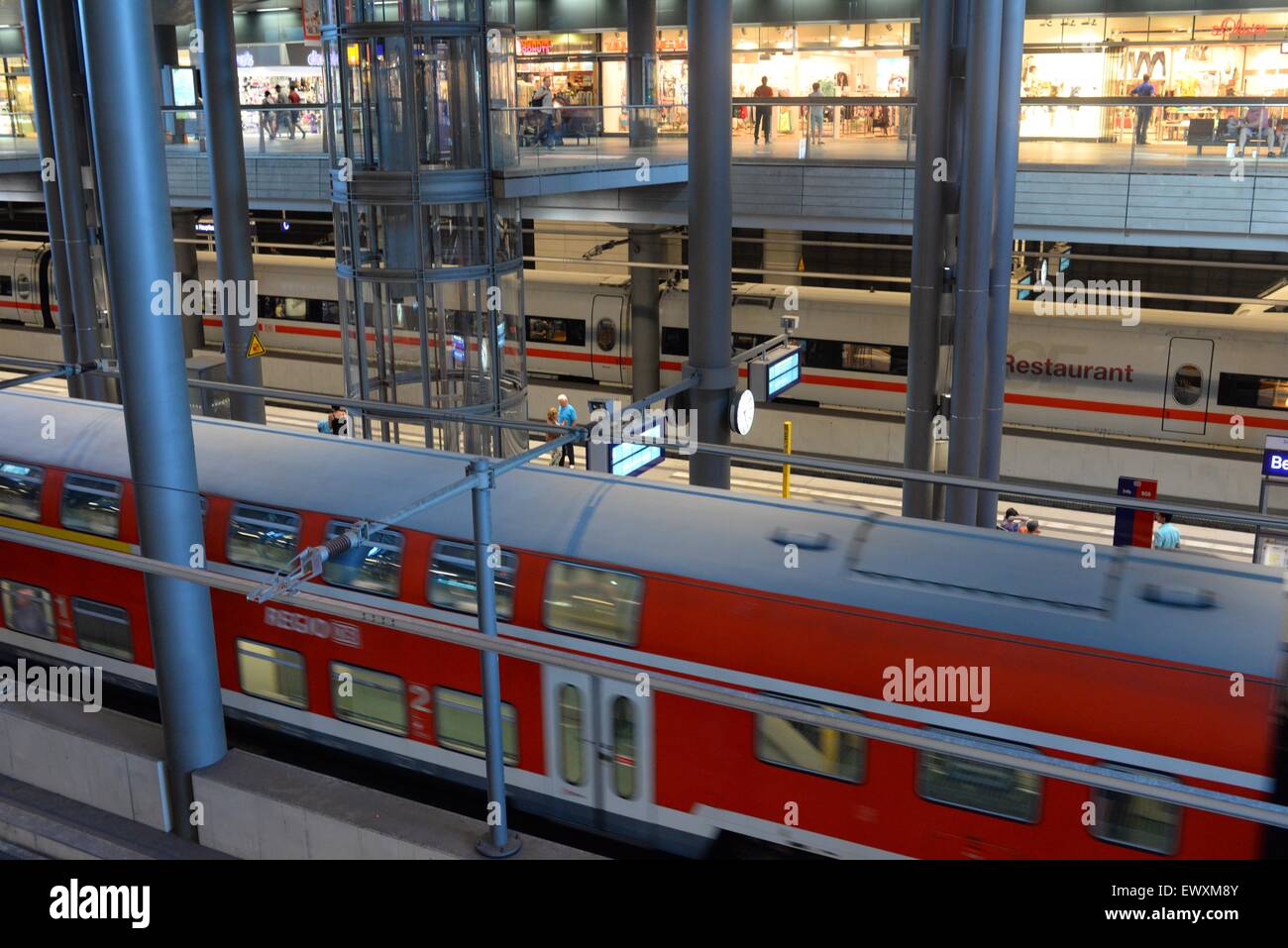 Inside Berlin Hauptbahnhof central railway station with trains passing ...