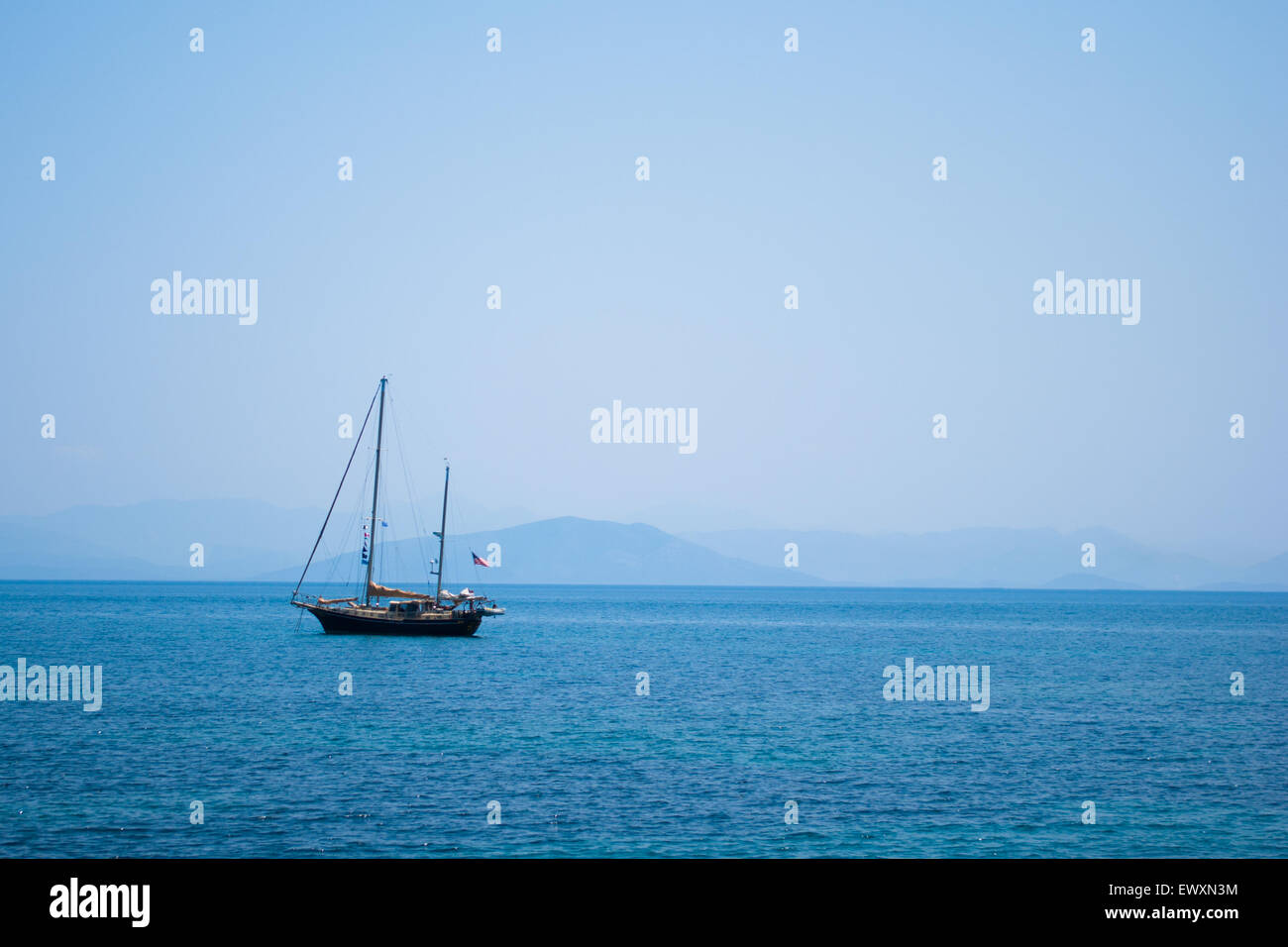 Boat sailing in blue waters Stock Photo - Alamy