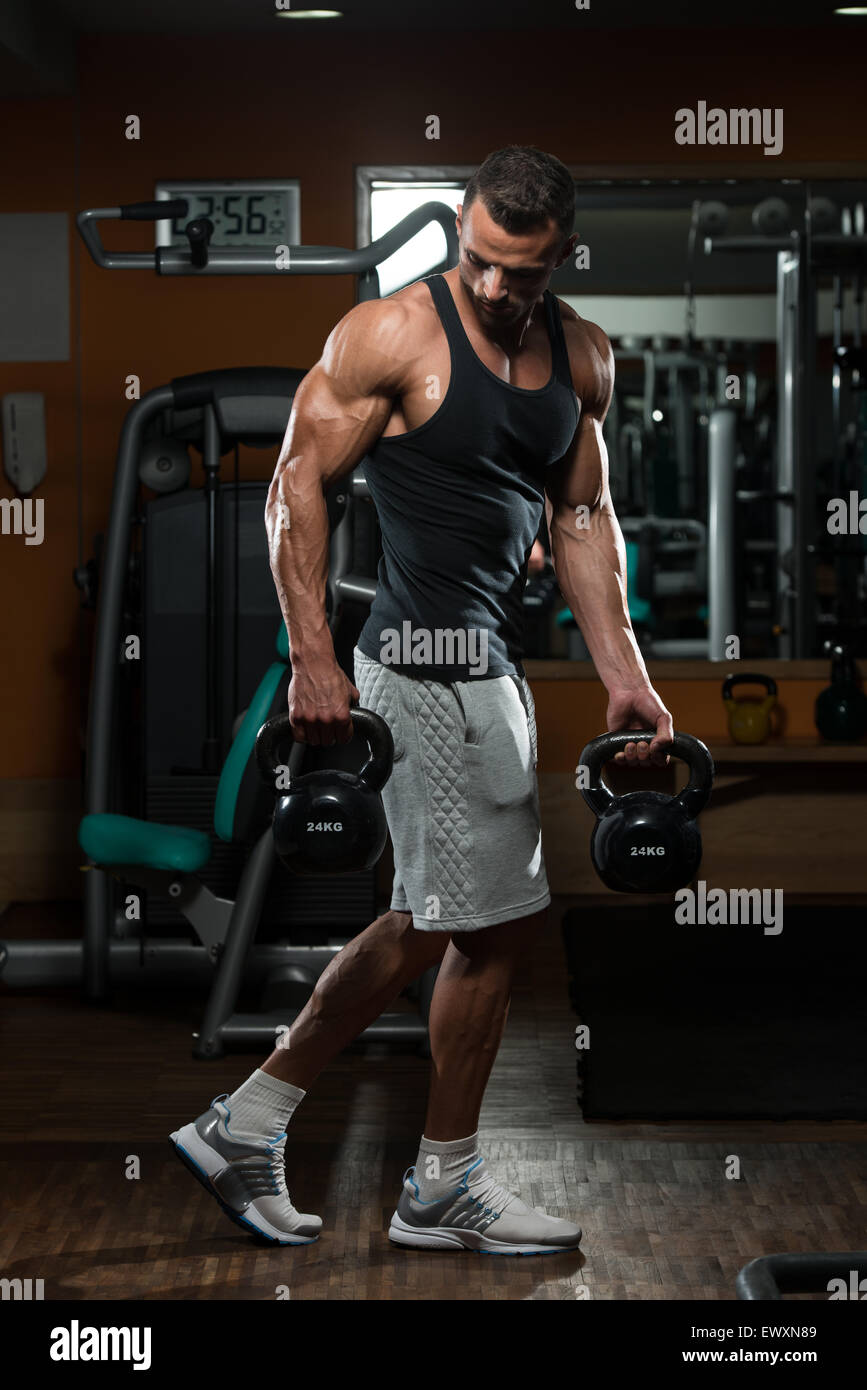 Muscular Man Exercise With Kettle Bell Stock Photo - Alamy