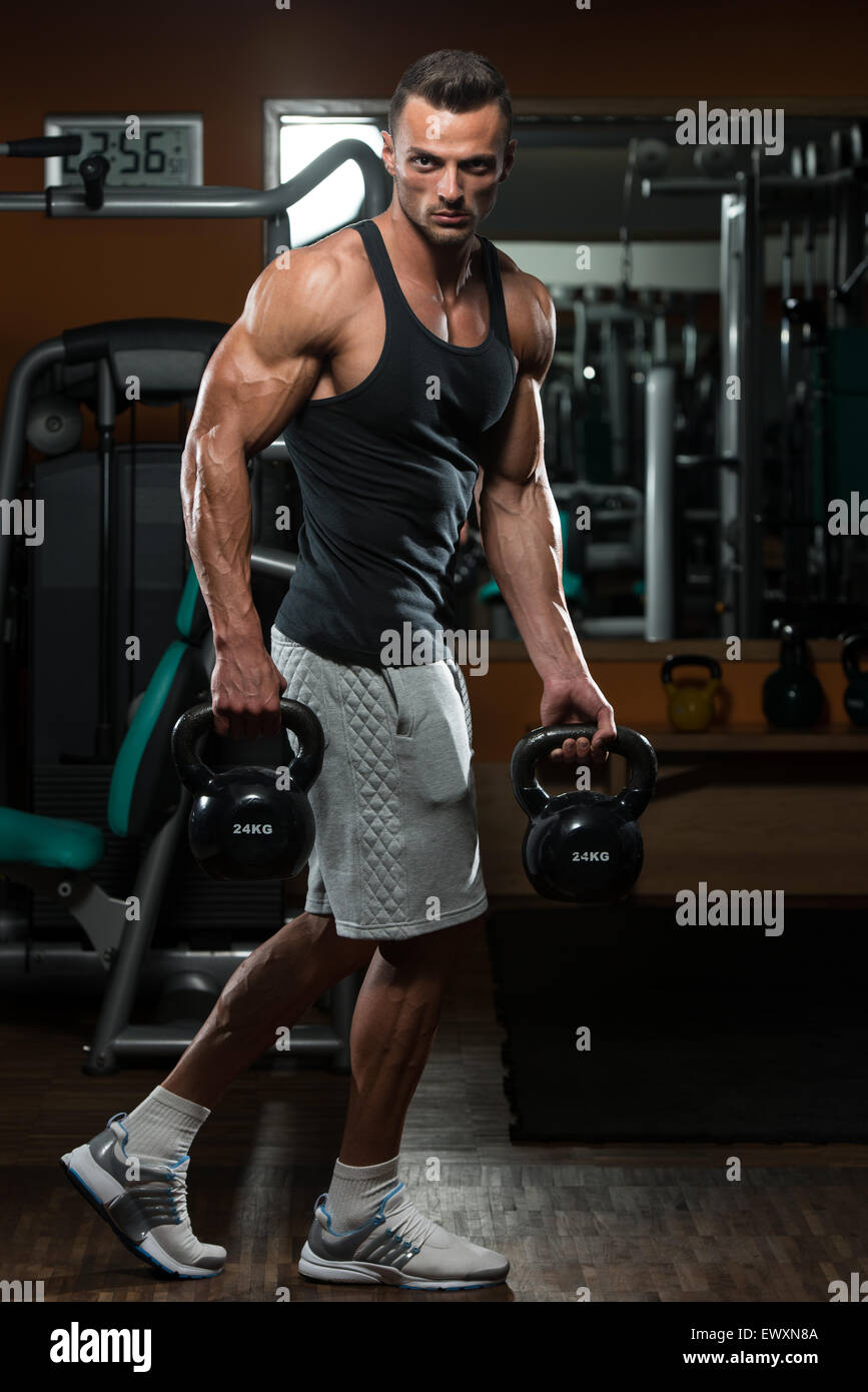 Muscular Man Exercise With Kettle Bell Stock Photo - Alamy