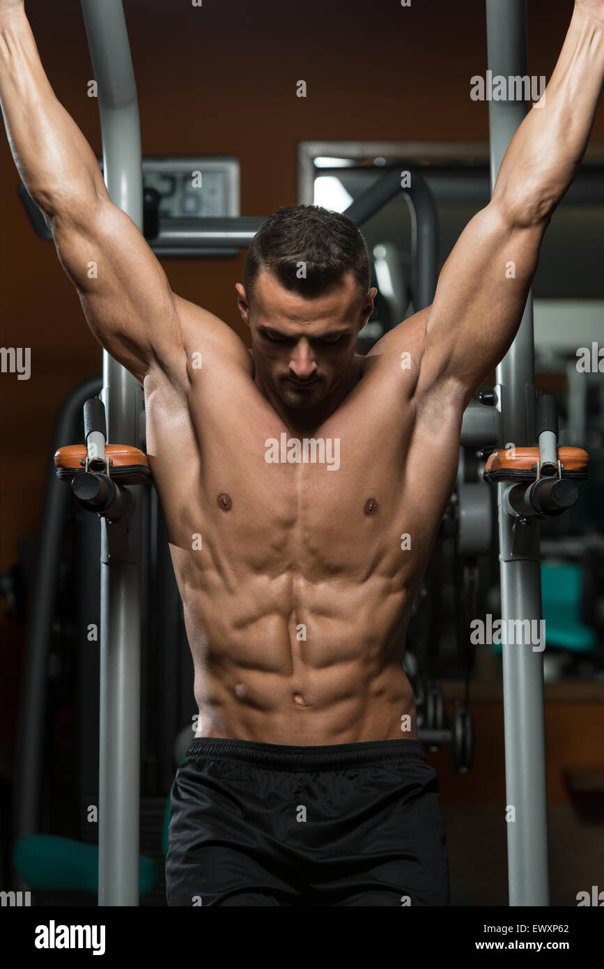 Young Men Performing Hanging Leg Raises One Of The Best Abs Exercises Stock Photo Alamy
