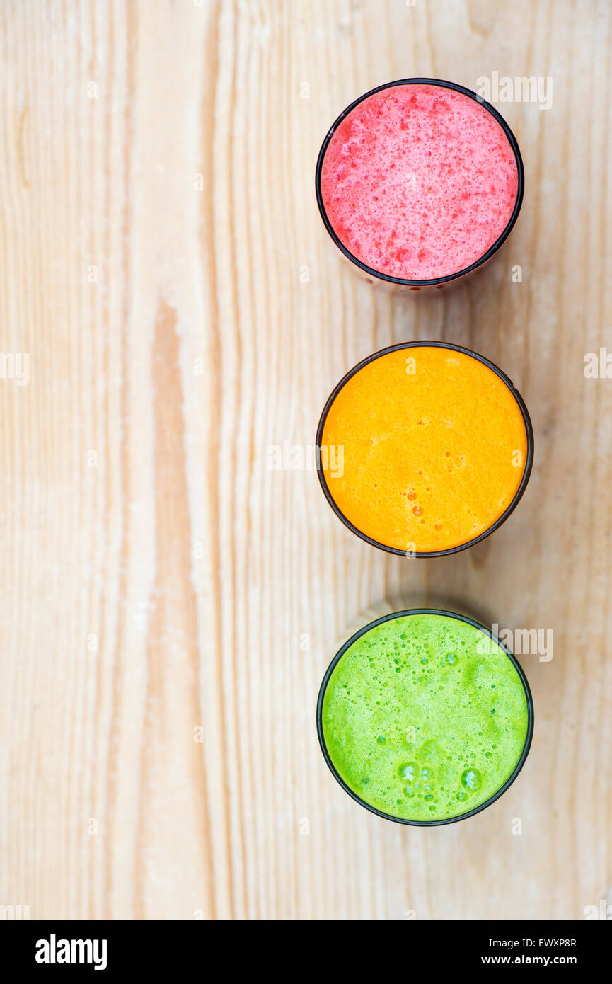 Strawberry, Carrot and Green Leaf smoothies in a traffic light formation Stock Photo