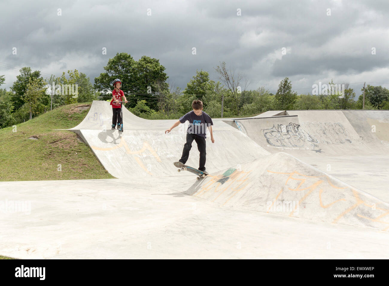 Two teenage boys using a skateboard park in Cannington, Ontario Canada Stock Photo