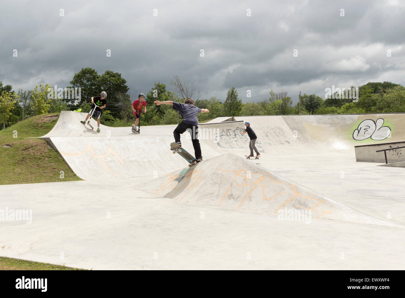 Three teenage boys using a skateboarding park in Cannington, Ontario Canada Stock Photo
