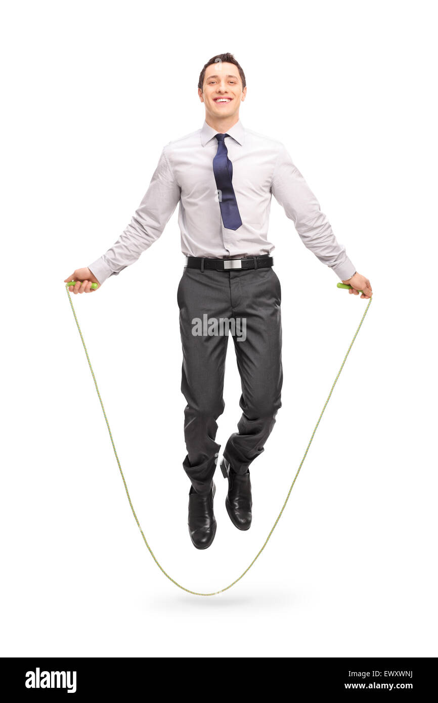 Full length portrait of a young cheerful businessman jumping a rope and ...
