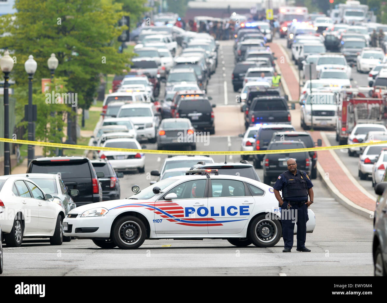 Washington, DC, USA. 2nd July, 2015. A policeman guards near the scene of a shooting at Navy Yard in Washington, DC, the United States, July 2, 2015. Police were responding to a report of an active shooter at the Washington Navy Yard in southeast of the U.S. capital Thursday morning, U.S. media reported. Credit:  Yin Bogu/Xinhua/Alamy Live News Stock Photo