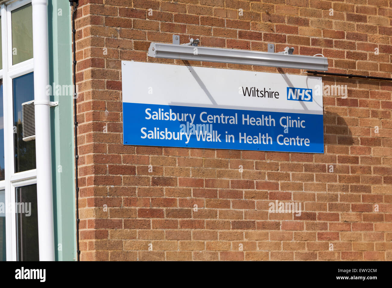 Wiltshire NHS sign on wall for Salisbury Central Health Clinic and Salisbury Walk in Health Centre in Salisbury Stock Photo