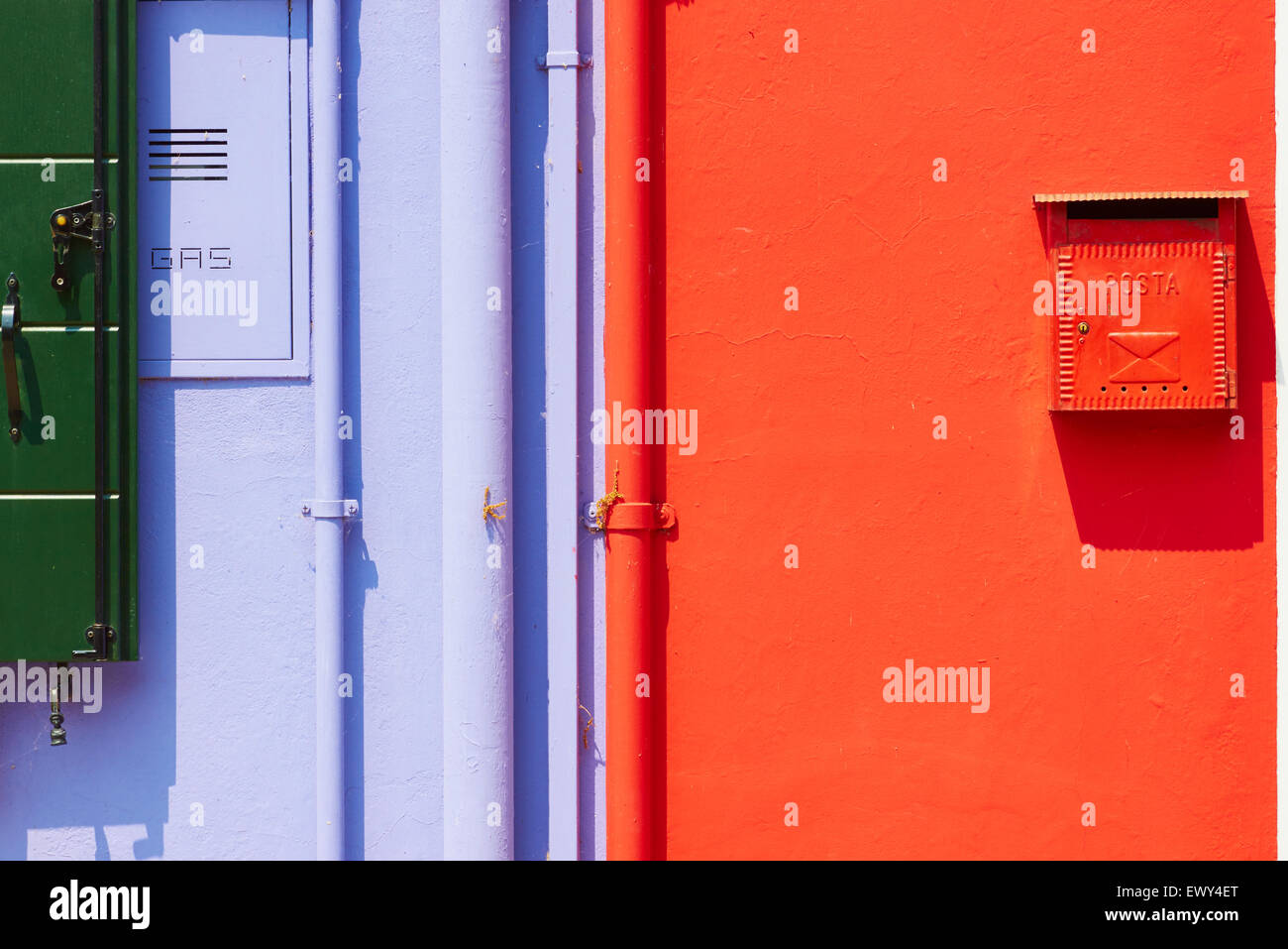Brightly painted wall with postbox gas services and pipes Burano Venetian Lagoon Veneto Italy Europe Stock Photo