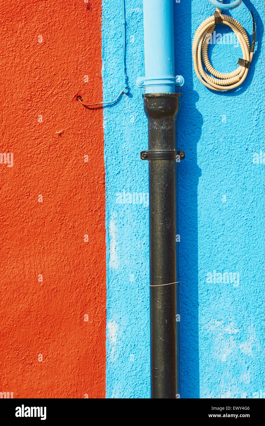 Pipes and wires on blue and rust coloured wall Burano Venetian Lagoon Veneto Italy Europe Stock Photo