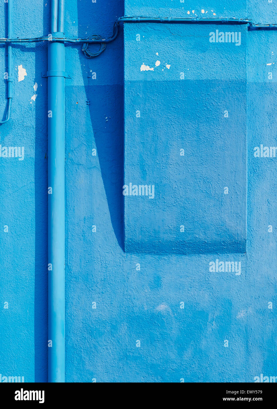 Blue peeling wall with pipes and wires Burano Venetian Lagoon Veneto Italy Europe Stock Photo