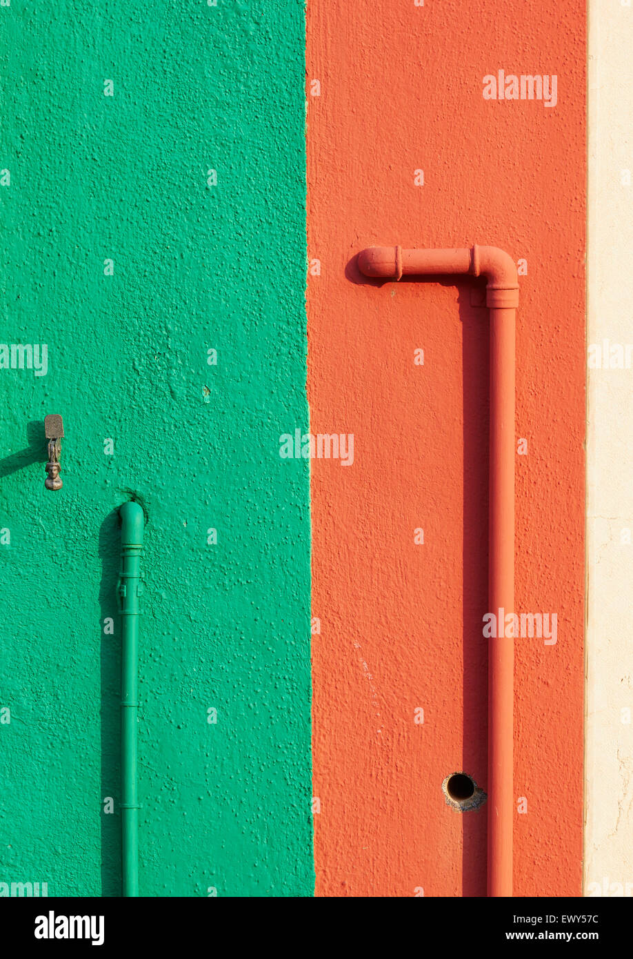 Orange and green wall and pipes Burano Venetian Lagoon Veneto Italy Europe Stock Photo