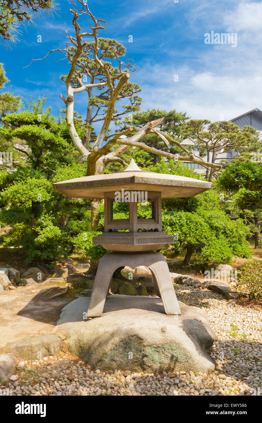 Traditional Japanese stone lantern (toro) in the park of Takamatsu