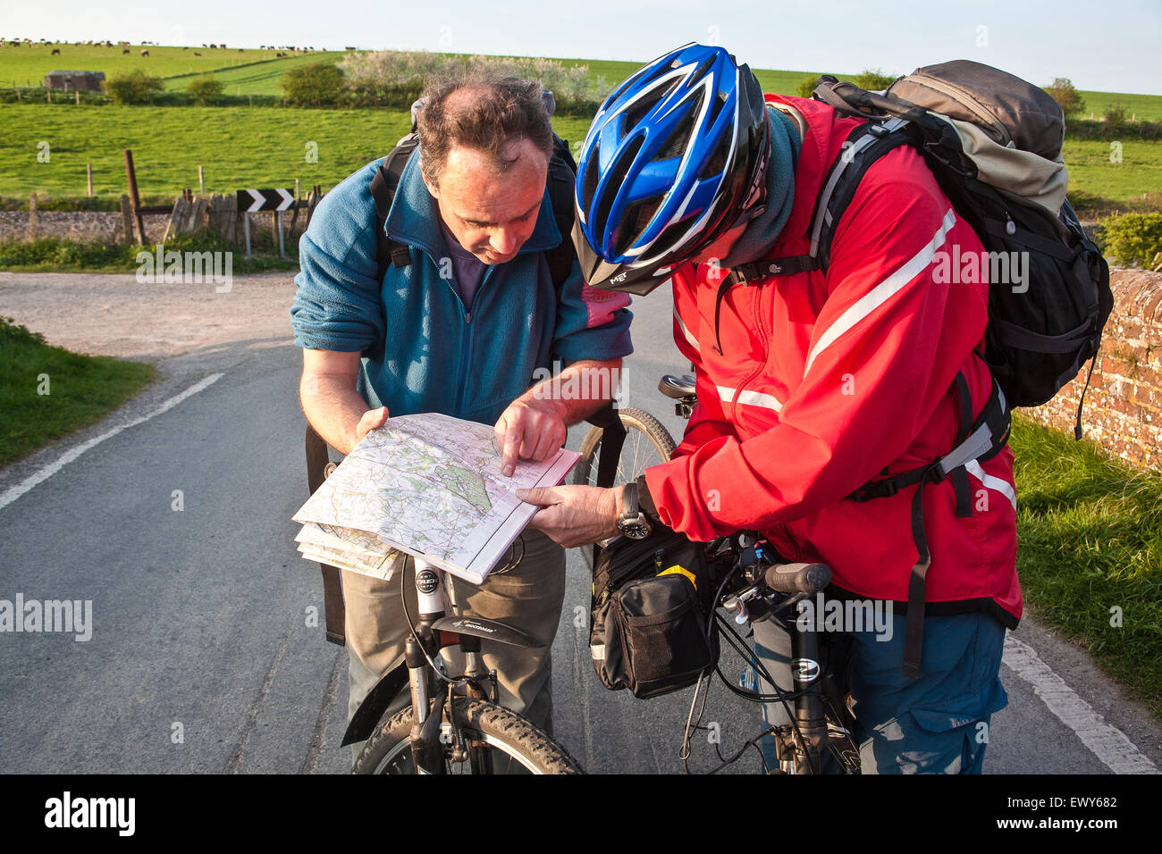 Cyclists on bridge above canal check map for directions. Part of the Kennet and Avon Cycle route(Bath to Reading) also known as Stock Photo