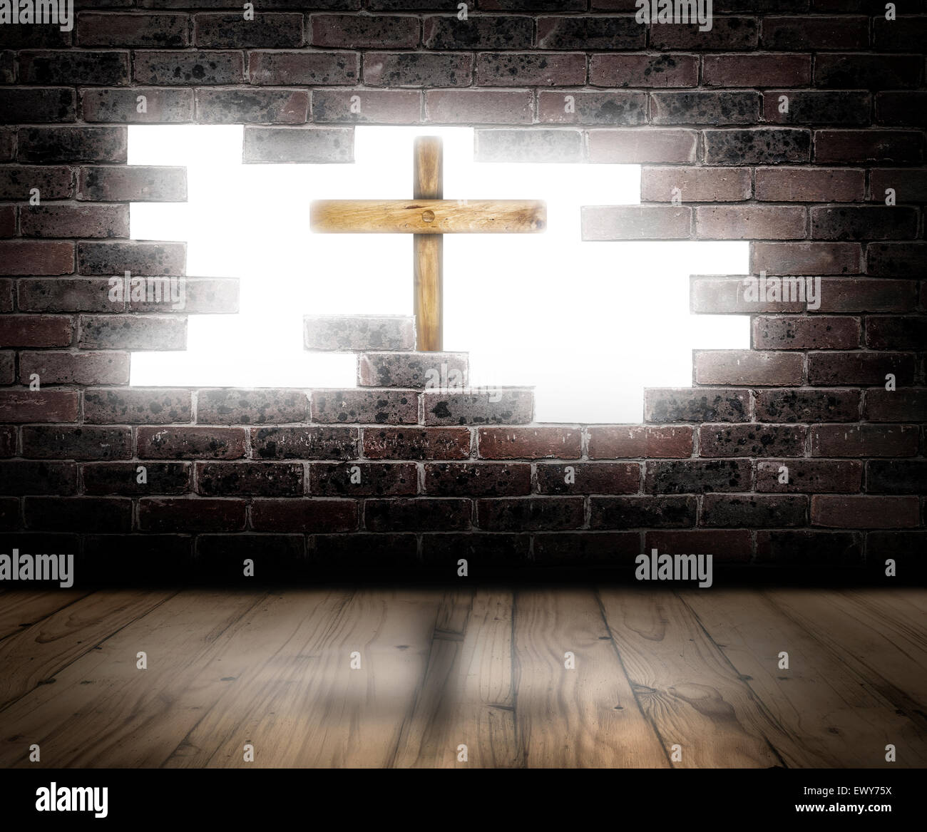 Wooden cross behind a broken brick wall with white light in the