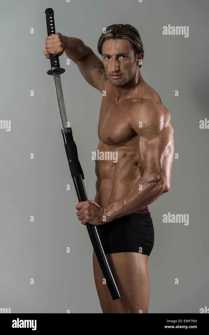 Portrait Of A Handsome Muscular Ancient Warrior With A Sword Stock ...