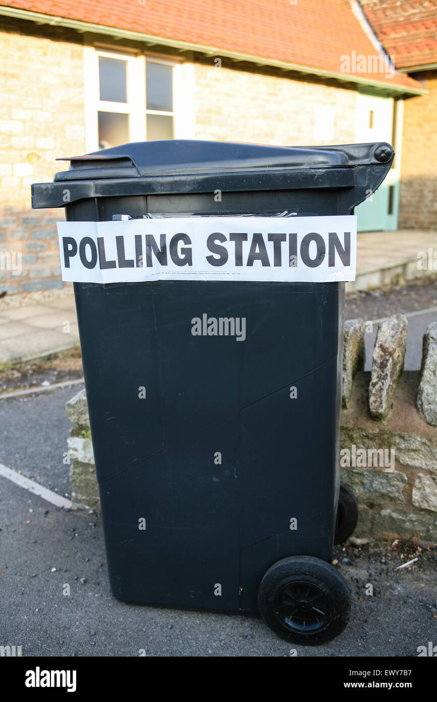 Temporary polling station for South Somerset District Council Parish elections on May 3rd 2007 at St Margaret's, Horsington Village Hall with sign placed on wheelie bin. Humorous as looks like vote goes straight into rubbish bin. Horsington,South Somerset, England. Stock Photo