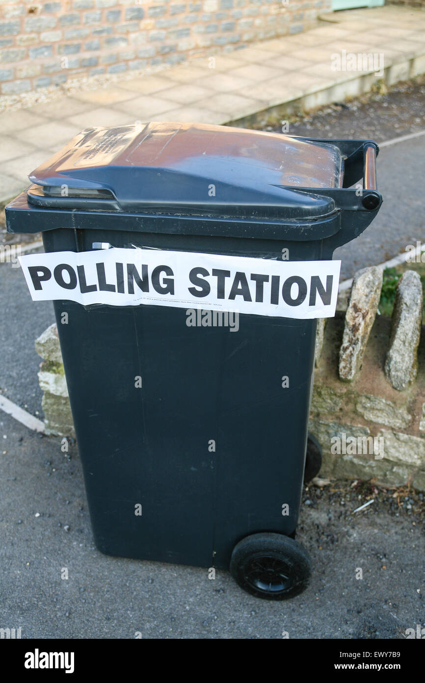 Temporary polling station for South Somerset District Council Parish elections on May 3rd 2007 at St Margaret's, Horsington Village Hall with sign placed on wheelie bin. Humorous as looks like vote goes straight into rubbish bin. Horsington,South Somerset, England. Stock Photo