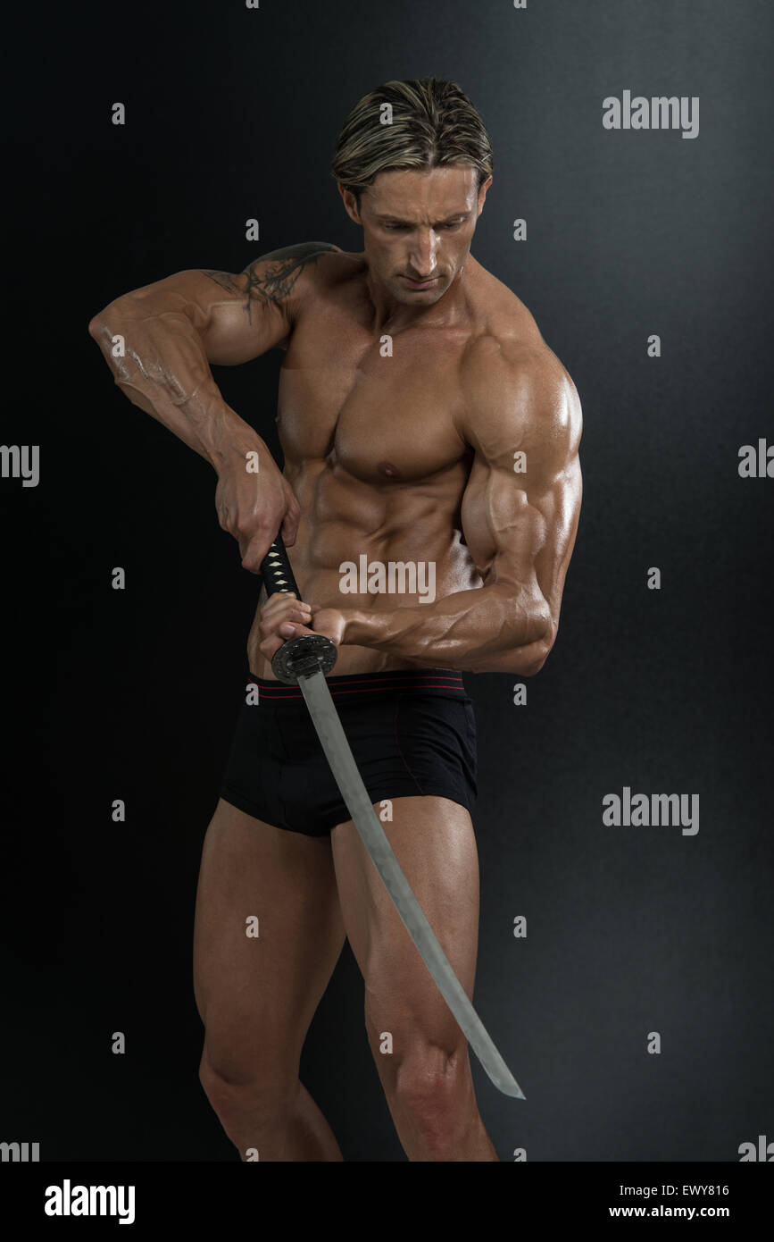 Portrait Of A Handsome Muscular Ancient Warrior With A Sword Stock ...