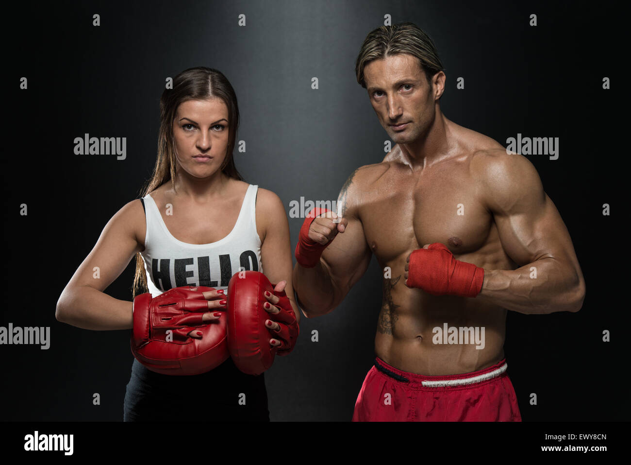 Bodybuilding Couple Posing With Boxing Gloves On Black Background Stock