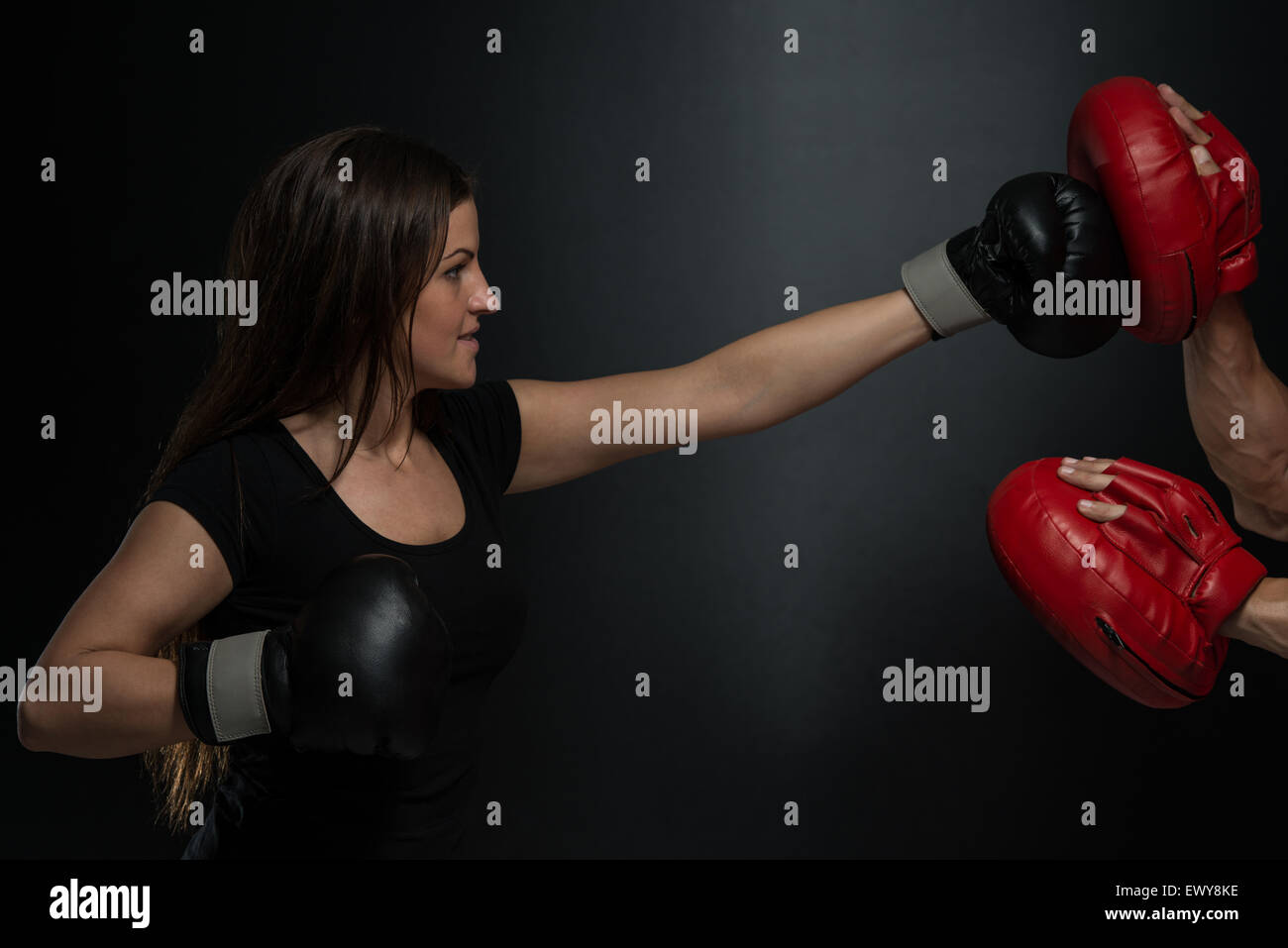 Bodybuilding Couple Posing With Boxing Gloves On Black Background Stock